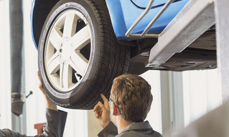 Man checking car Tyres